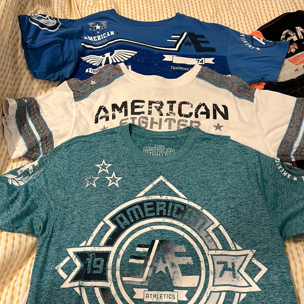 American fighter T-shirts all size extra large blue, white and gray.